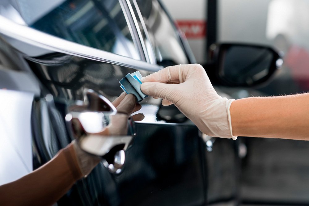 Applying a professional ceramic coating to a car in Honolulu, Oahu